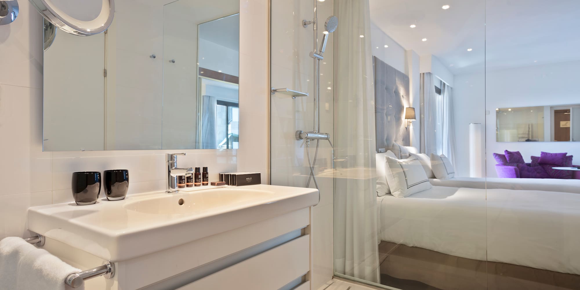 a bathroom with a shower and a bed