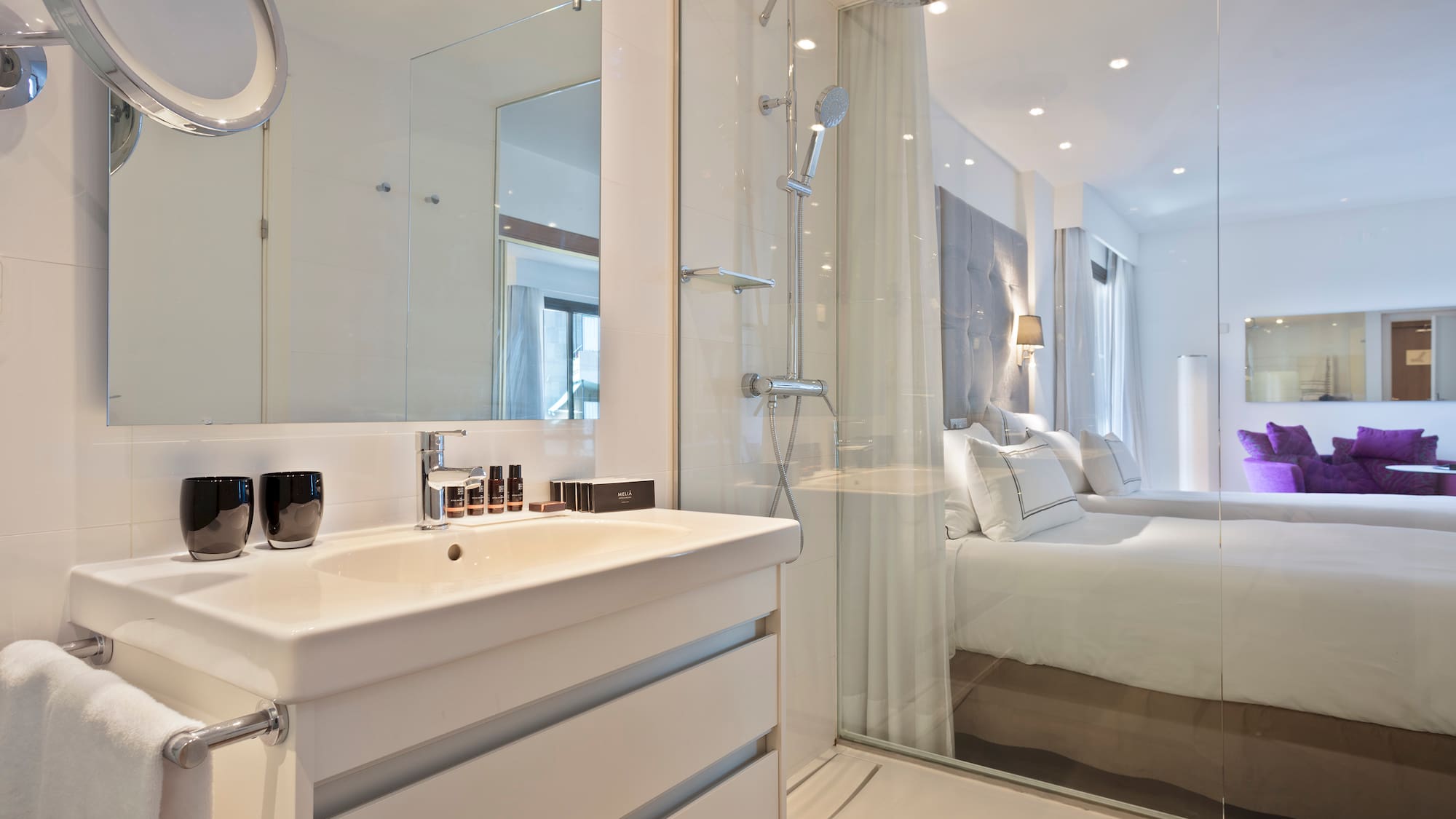 a bathroom with a shower and a bed