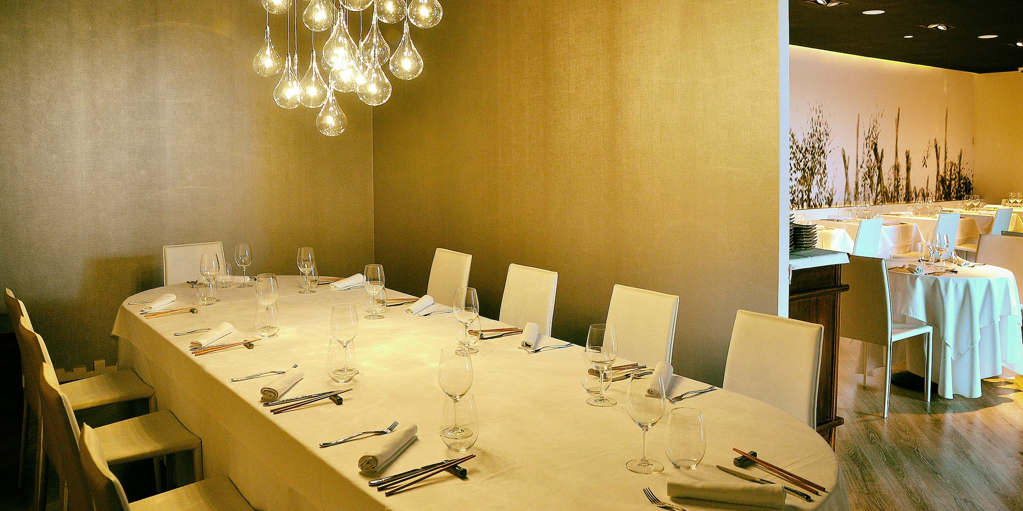 a table with a chandelier and glasses