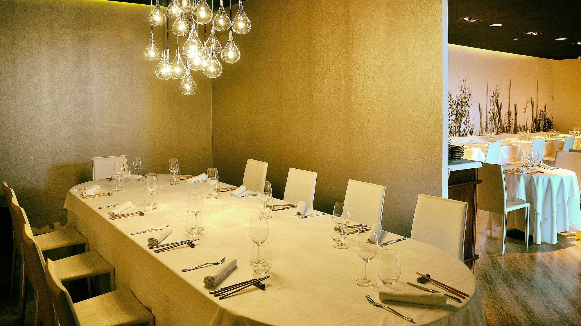 a table with a chandelier and glasses