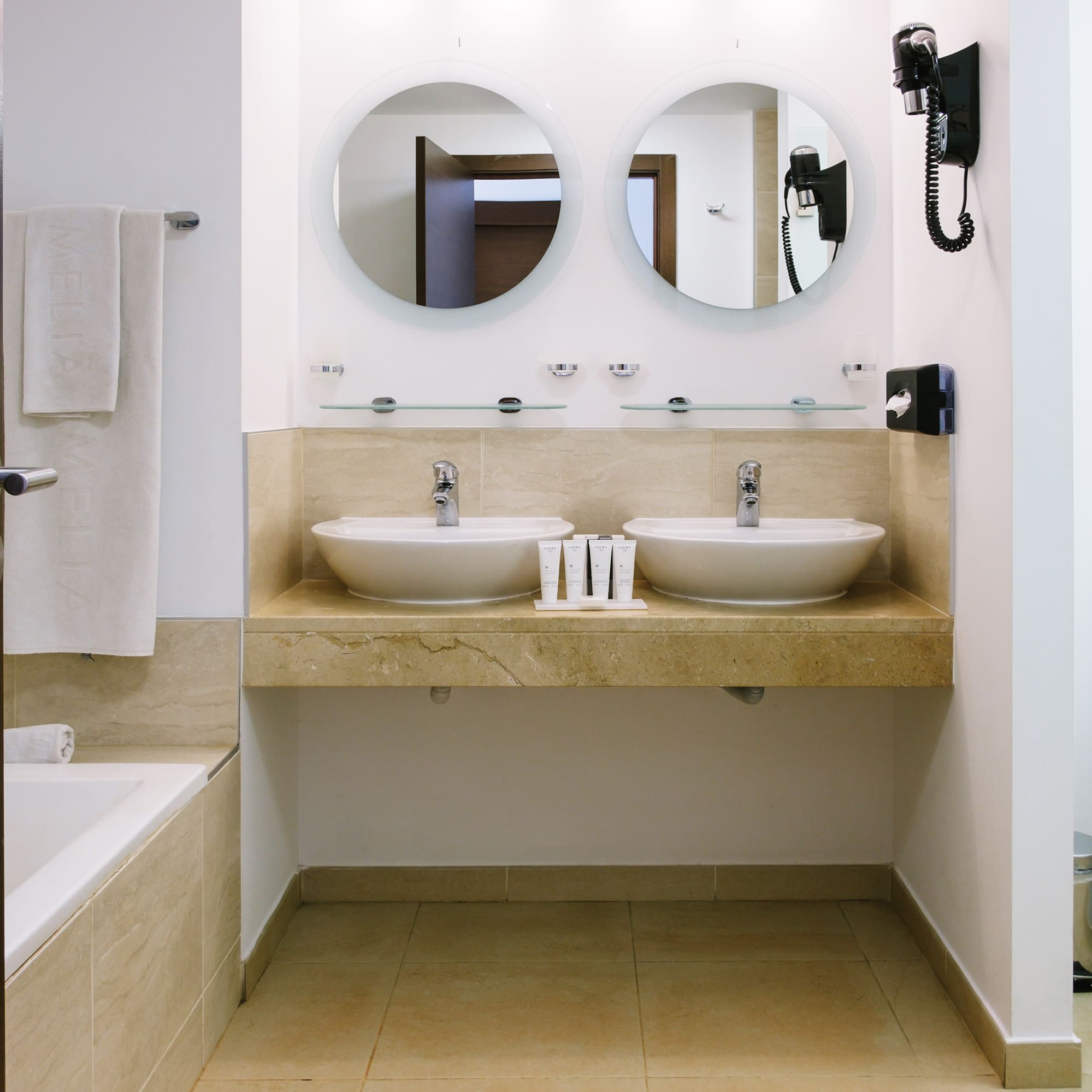 a bathroom with two sinks and a bathtub