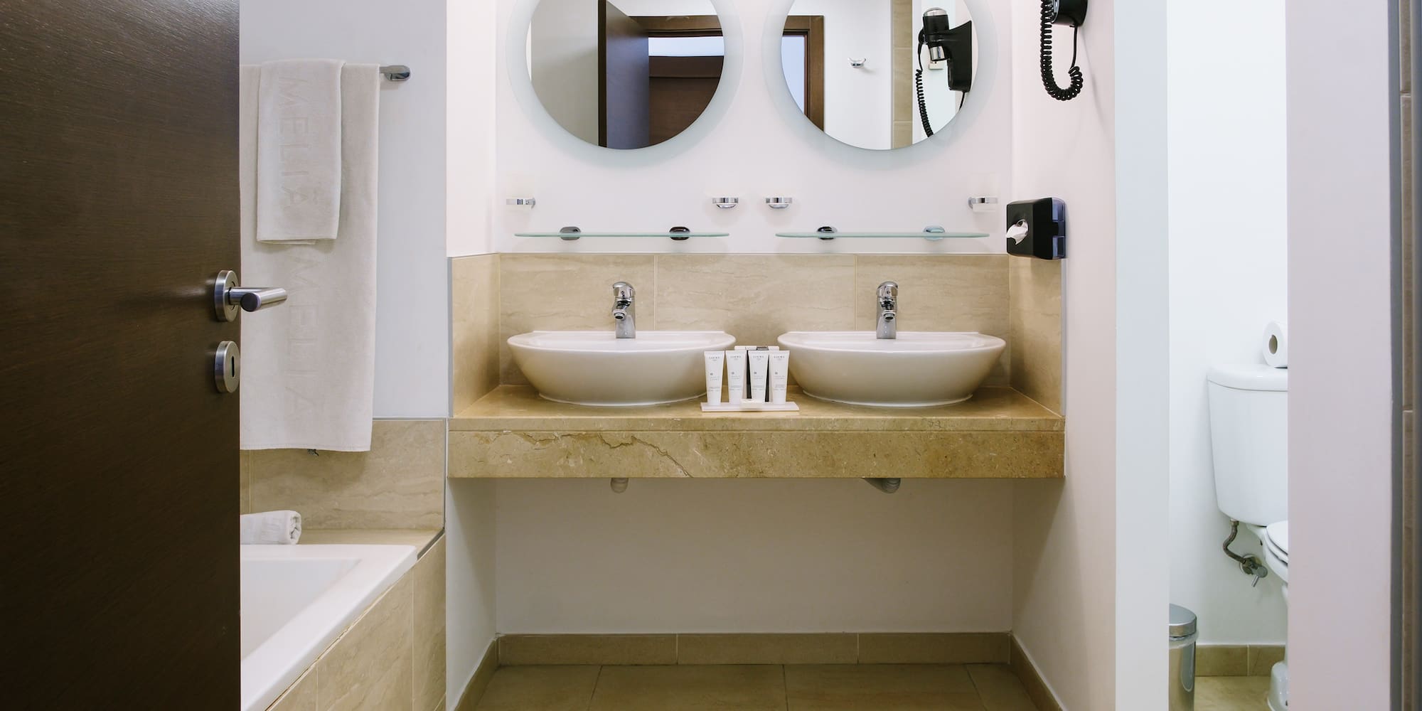 a bathroom with two sinks and a bathtub