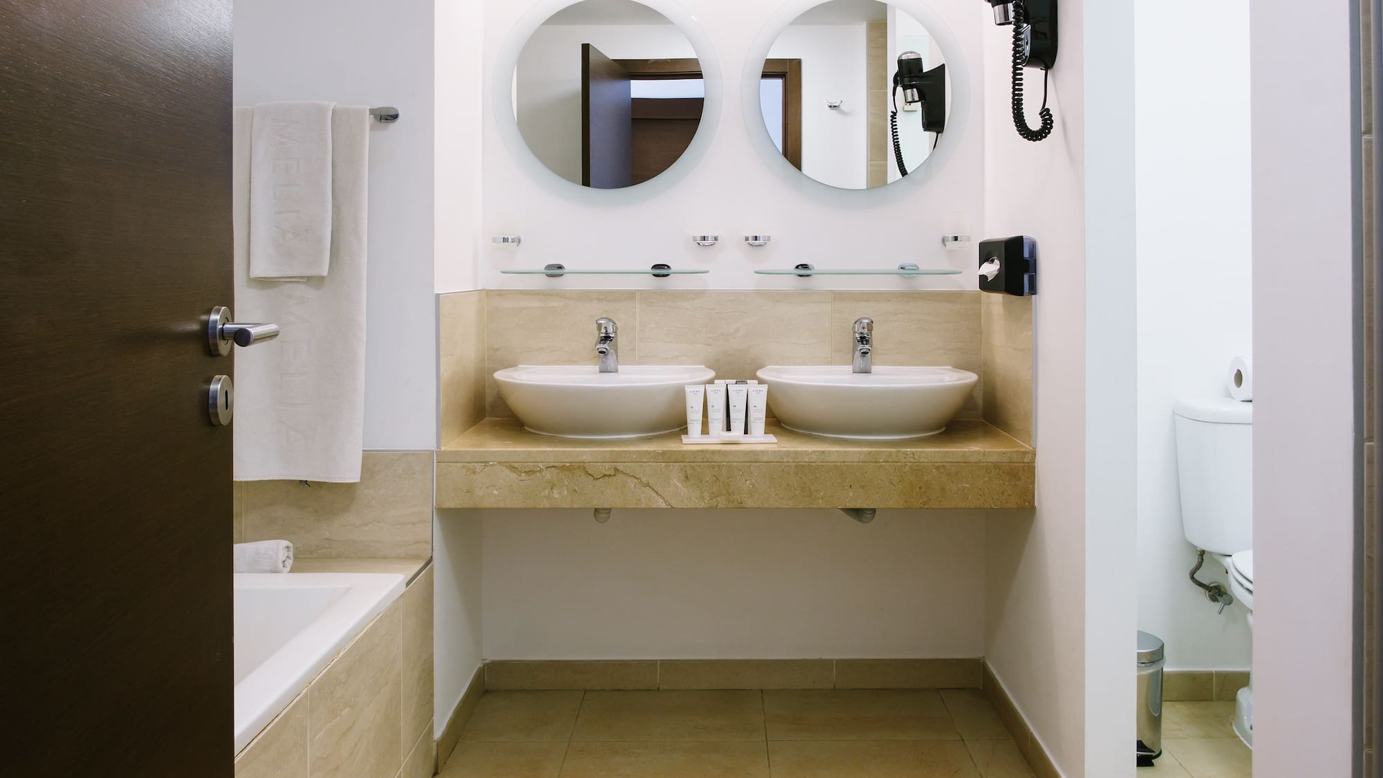 a bathroom with two sinks and a bathtub