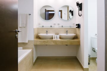 a bathroom with two sinks and a bathtub