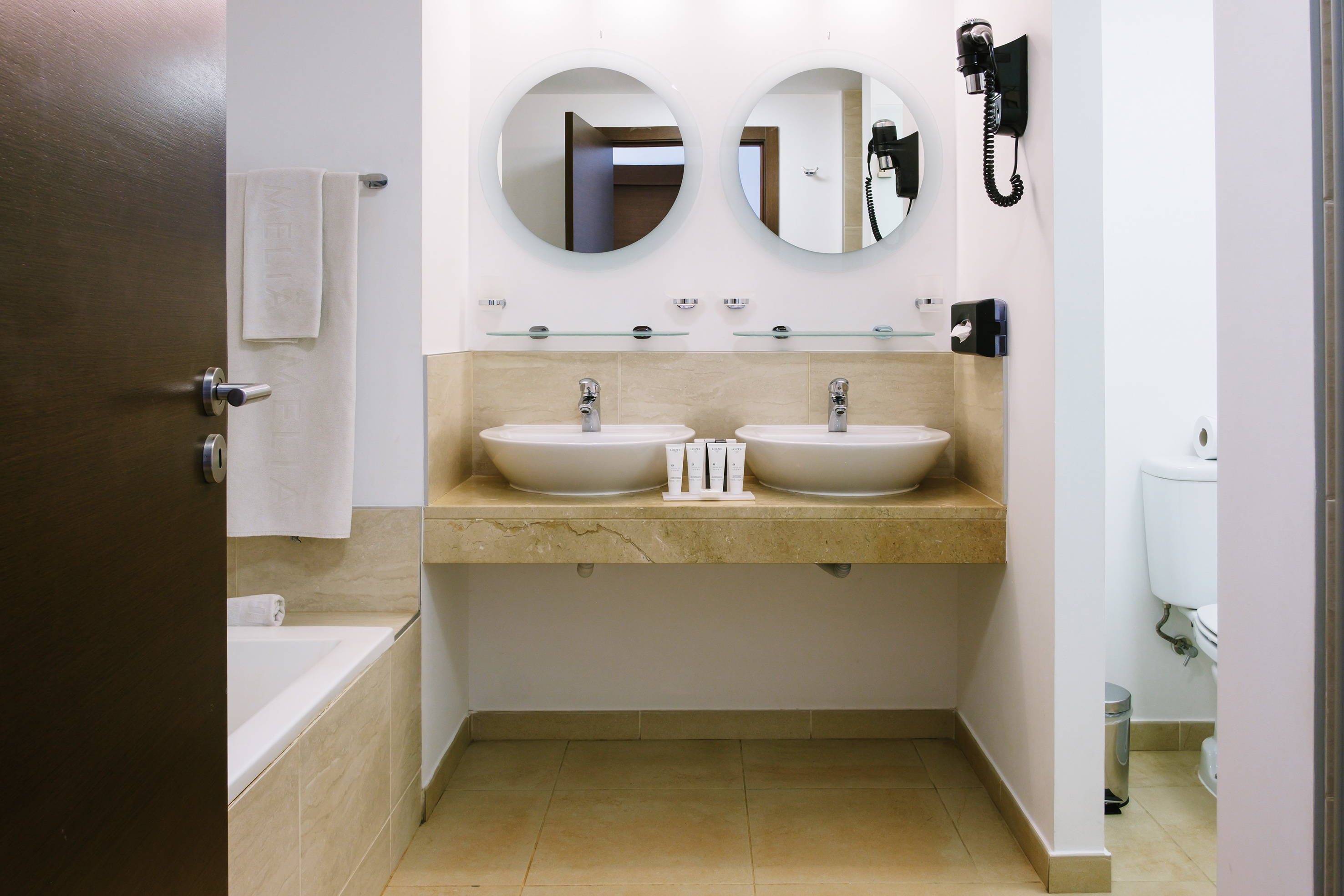 a bathroom with two sinks and a bathtub