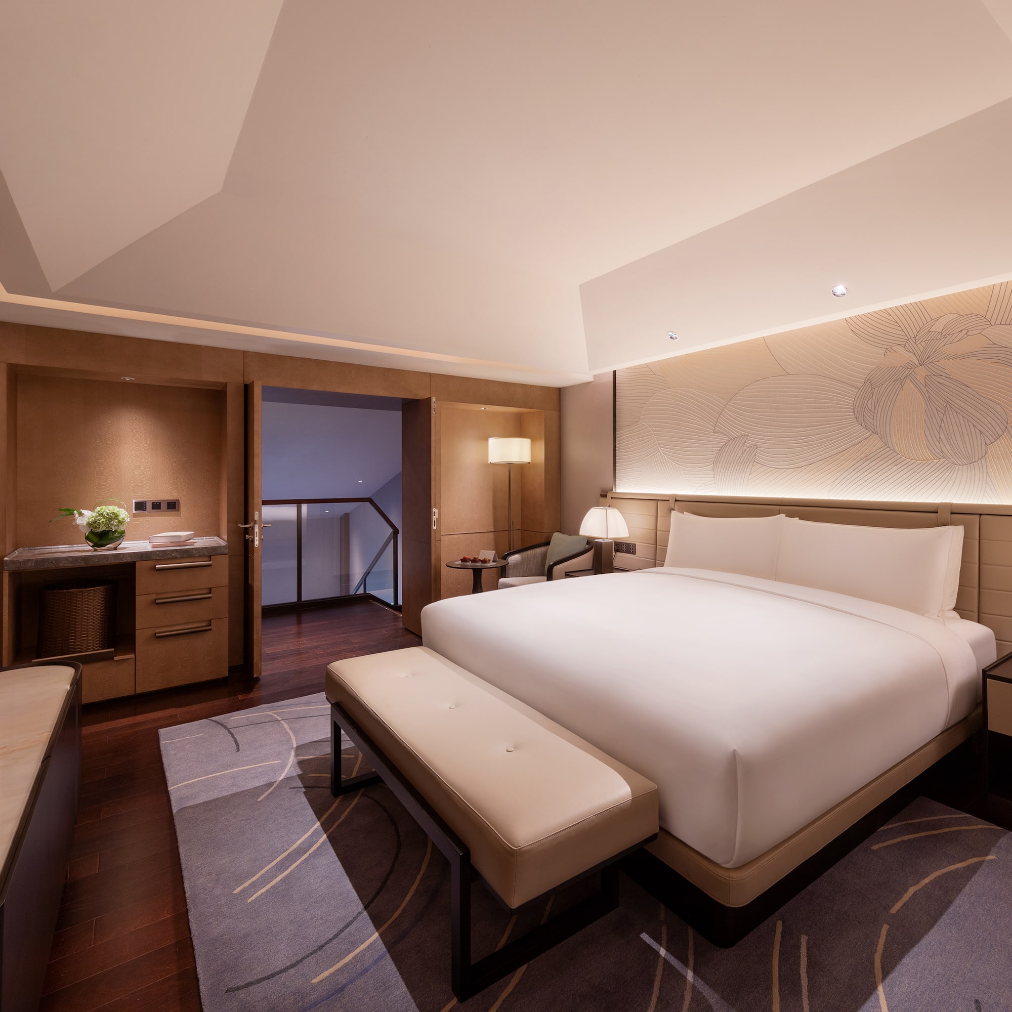 a room with a bed and a bench