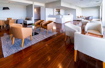 a room with a reception desk and chairs