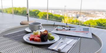 a plate of fruit and a cup of coffee on a table