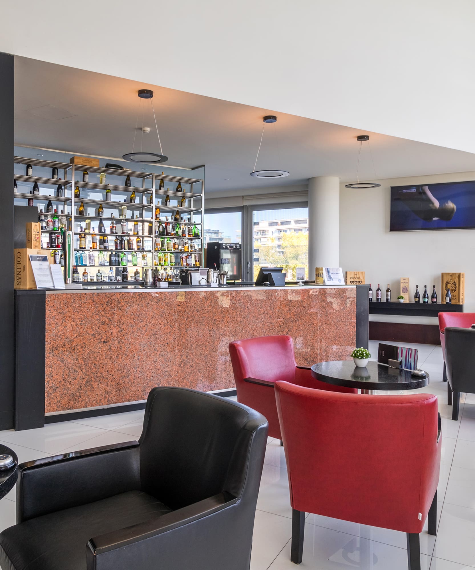 a room with a bar and chairs