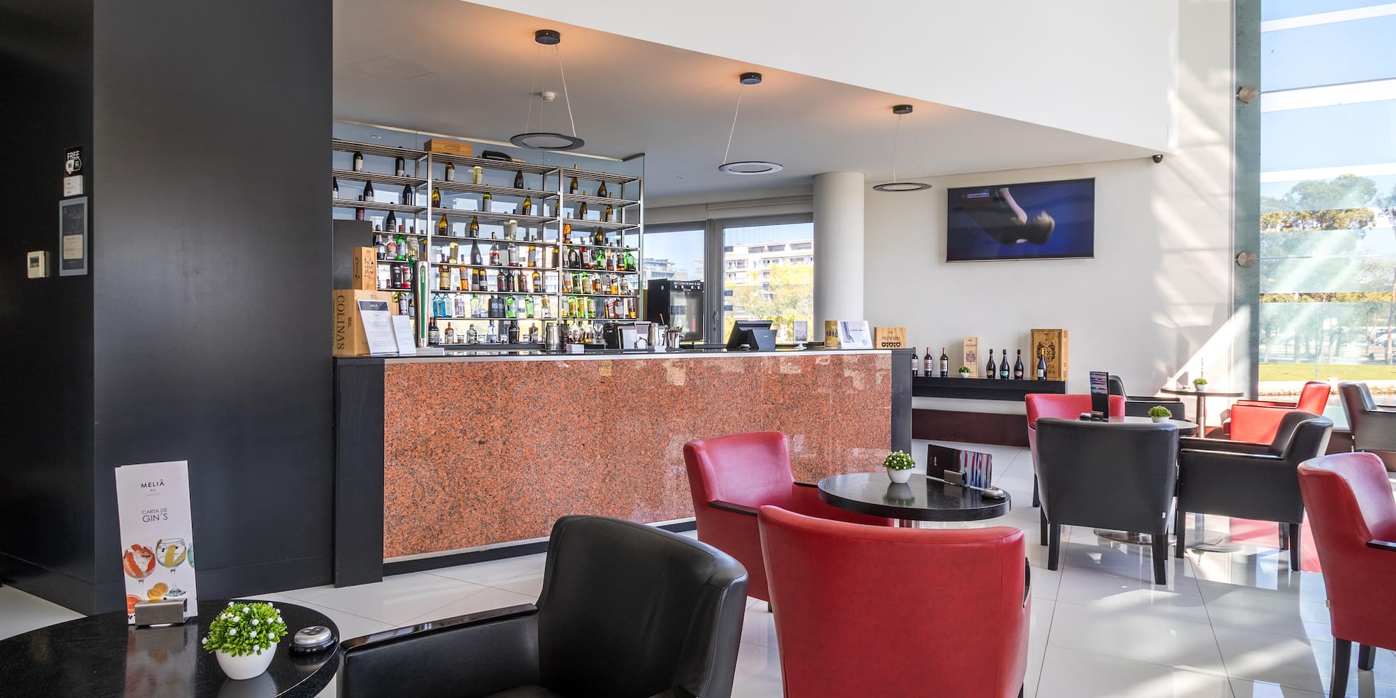 a room with a bar and chairs