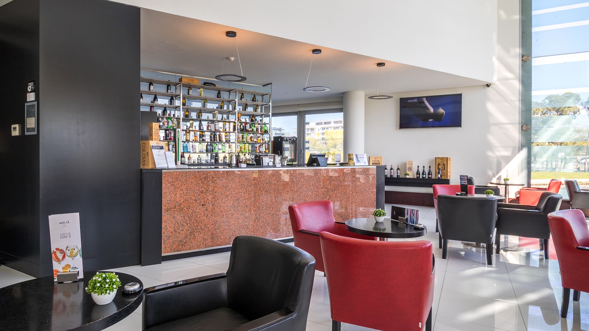 a room with a bar and chairs