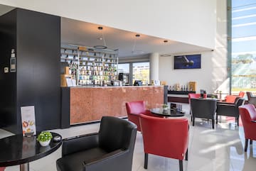 a room with a bar and chairs