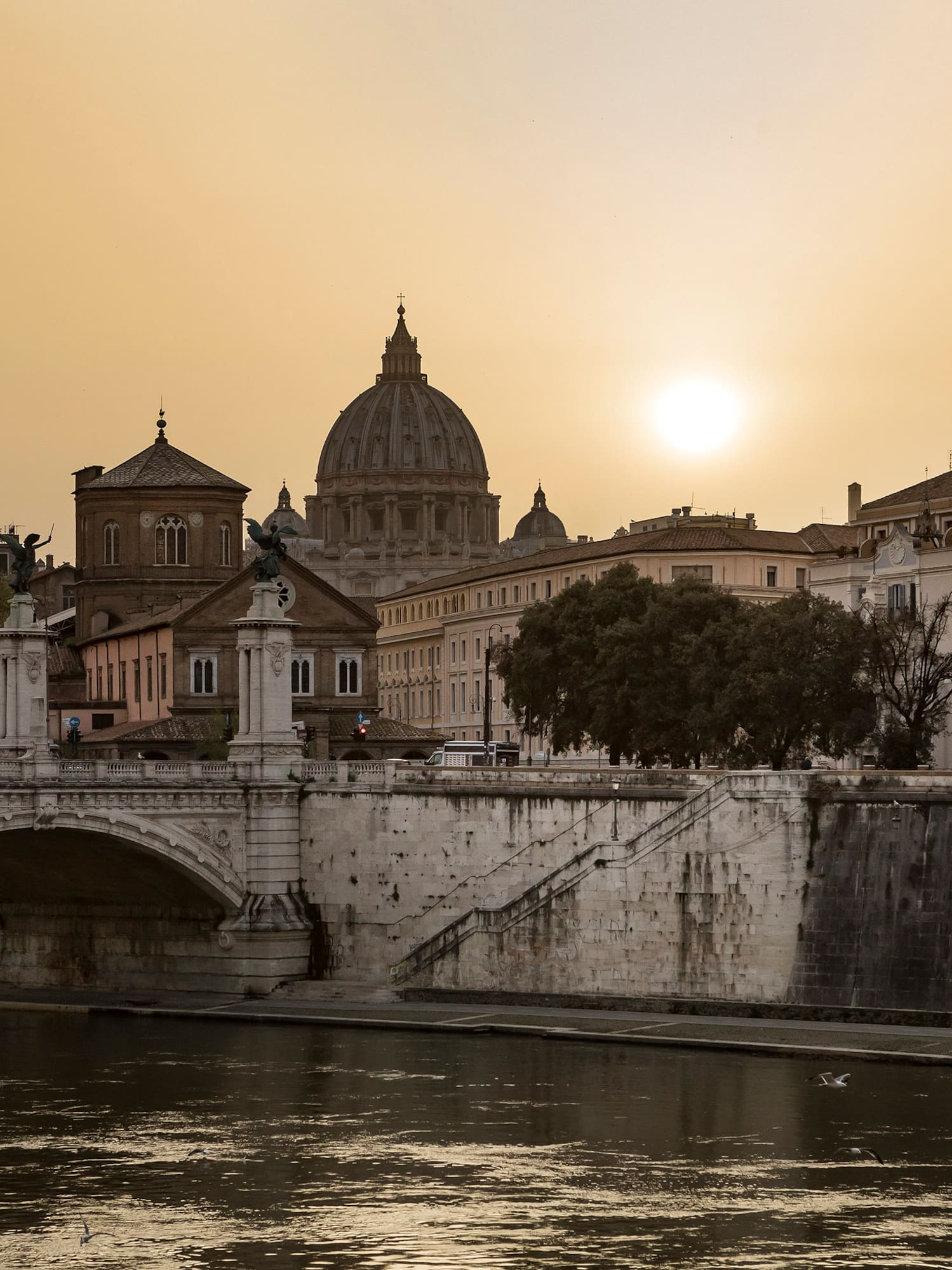 a bridge over a river with buildings in the background