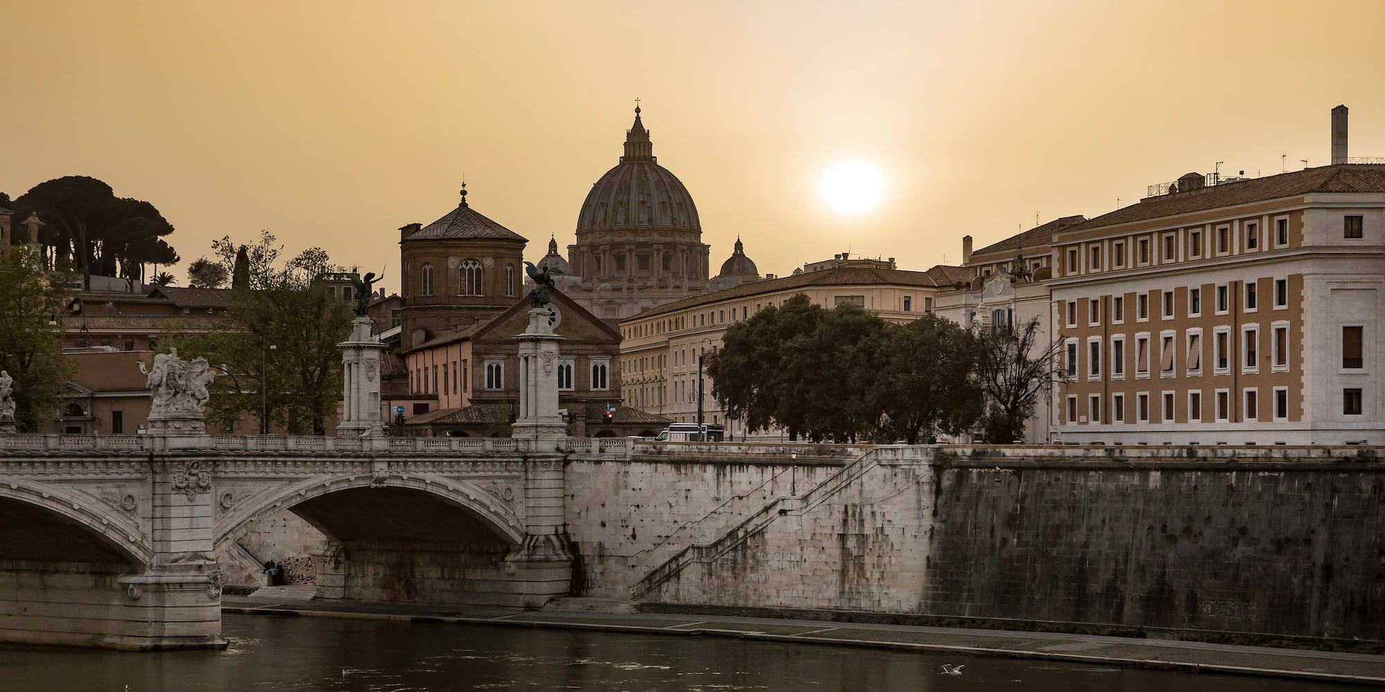 a bridge over a river with buildings in the background