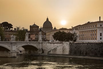a bridge over a river with buildings in the background