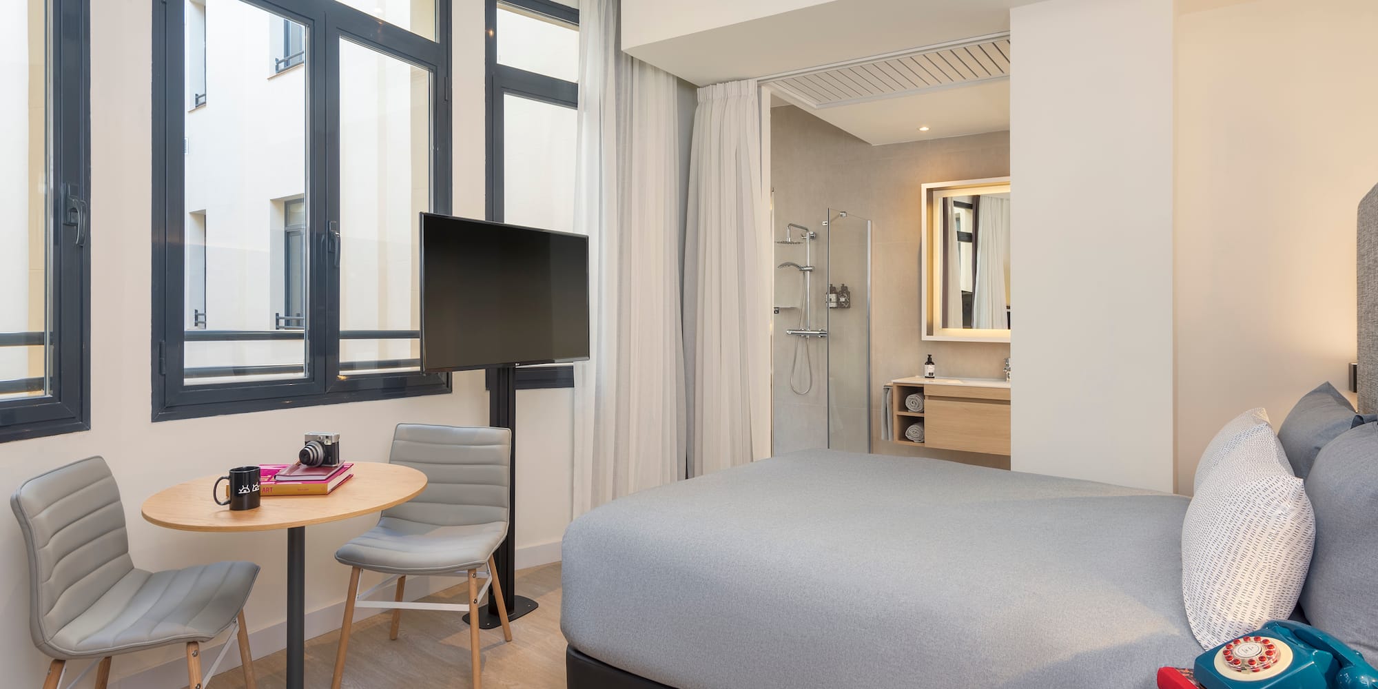 a room with a bed and a table and chairs