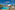 a pool with lounge chairs and a building