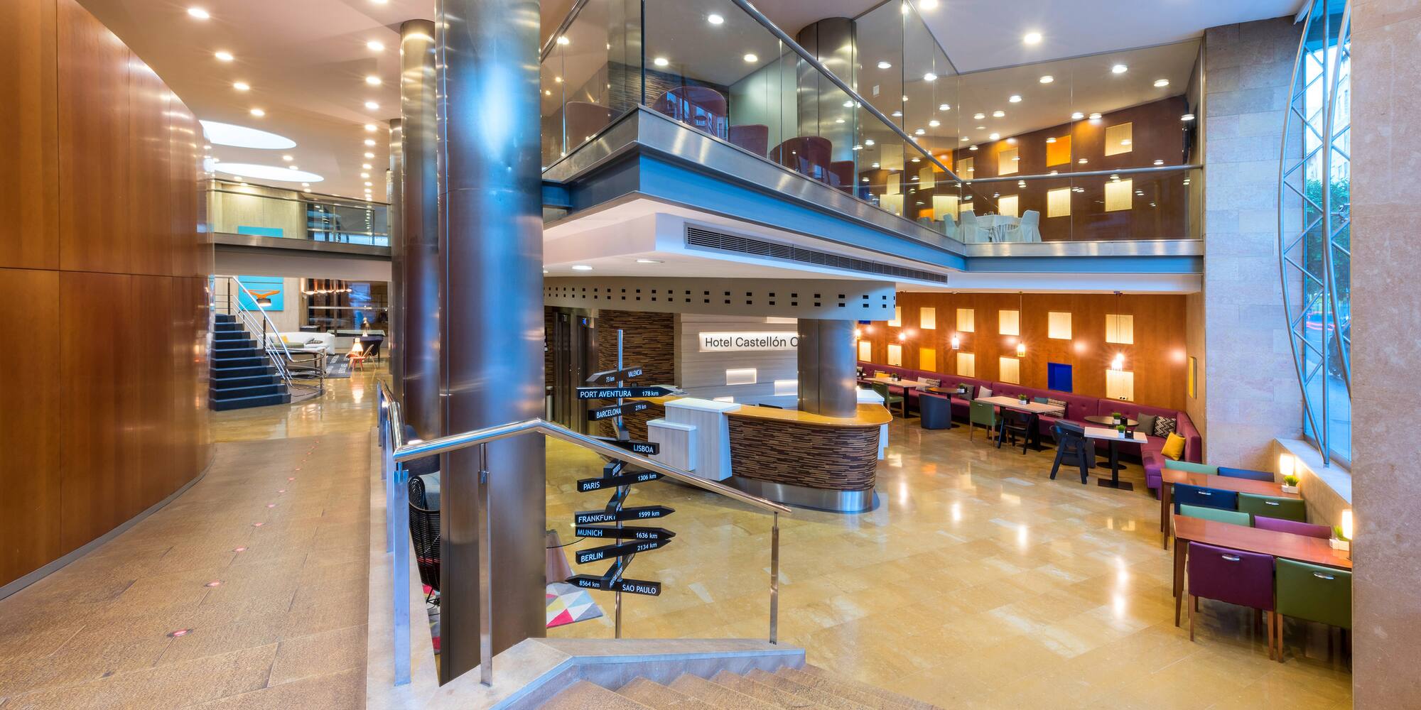 a large building with a glass wall and stairs