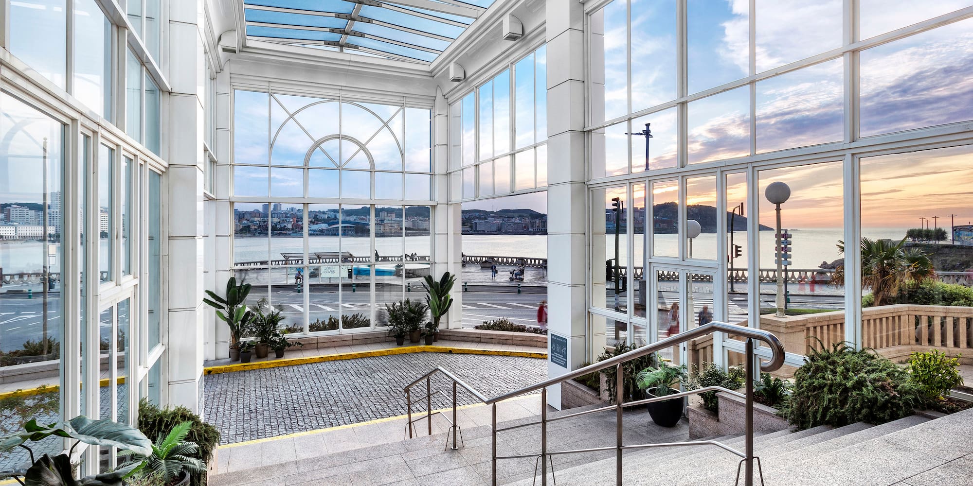 a glass building with stairs and railings