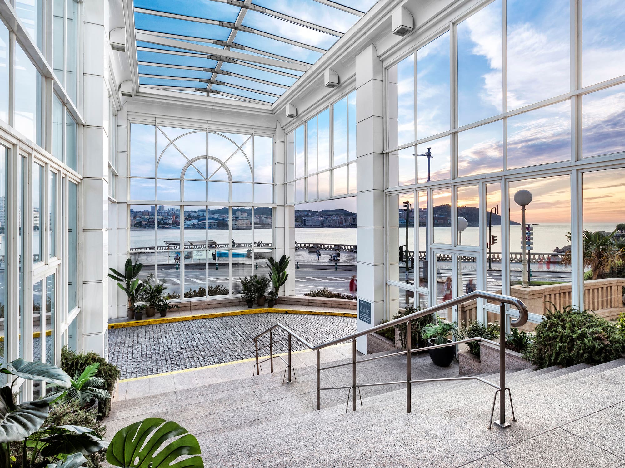 a glass building with stairs and railings
