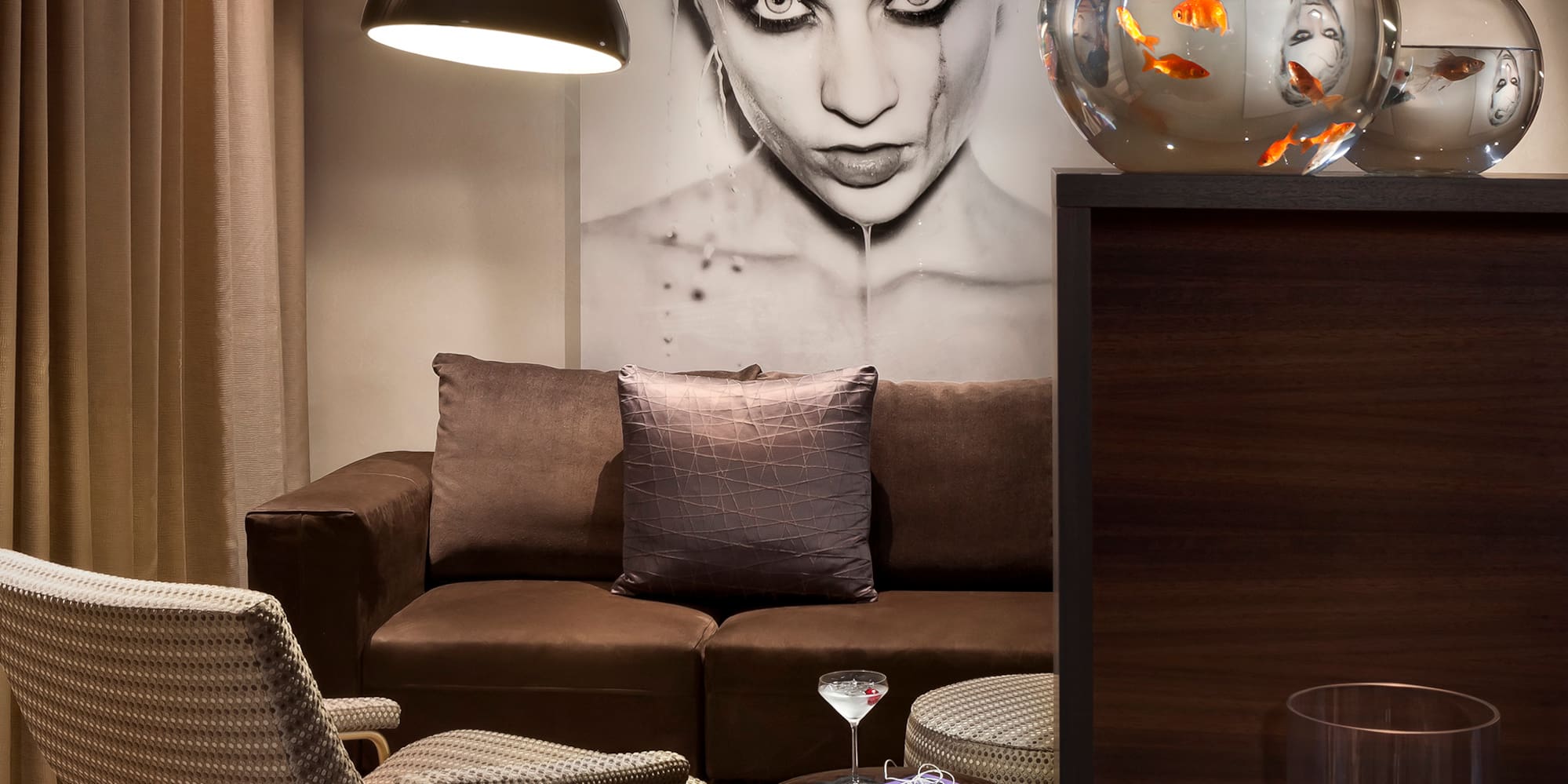 a living room with a couch and fish bowl