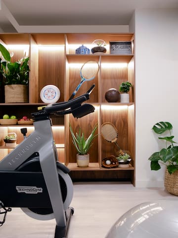 a exercise bike in a room with shelves and plants