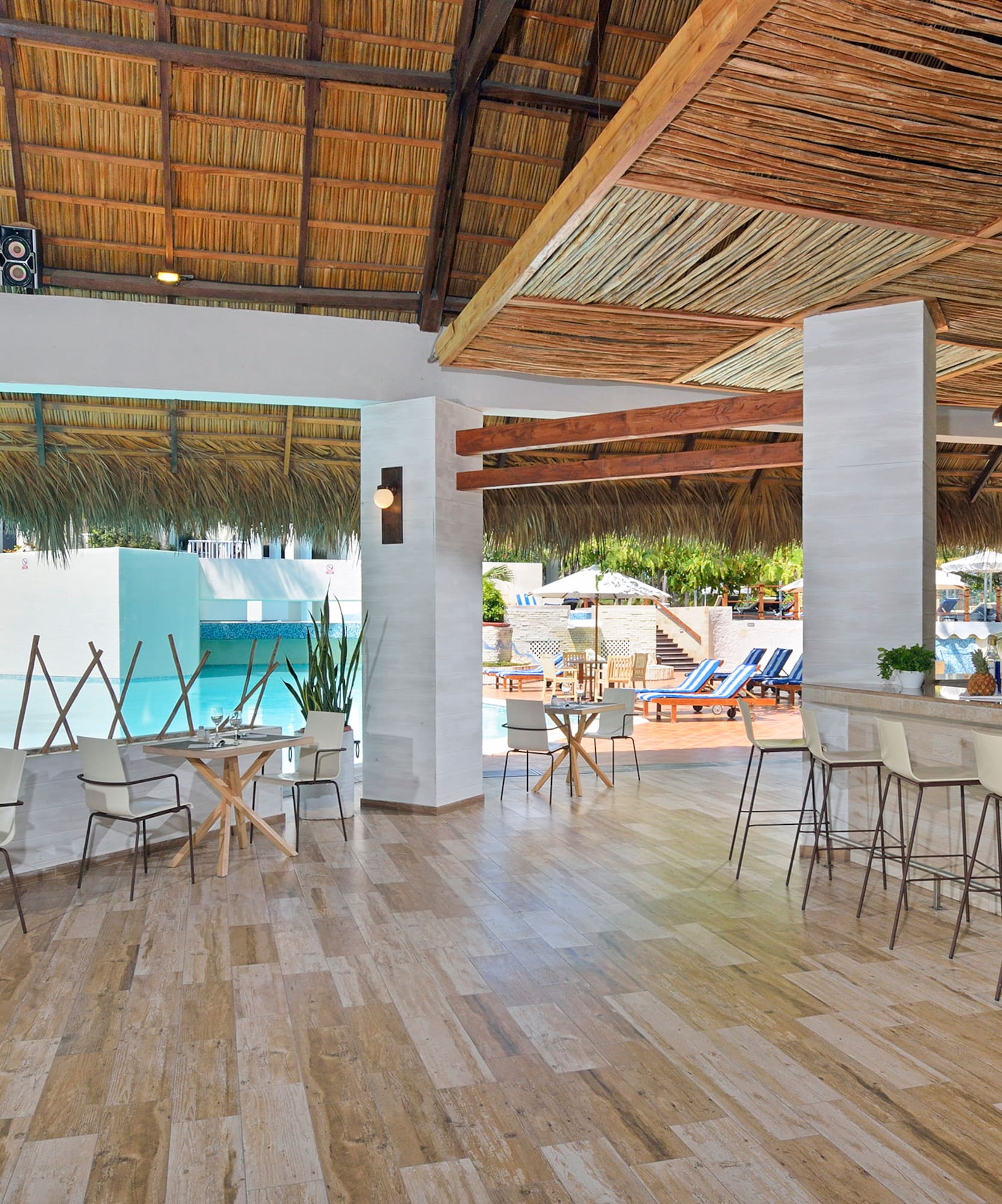 a room with a bar and chairs