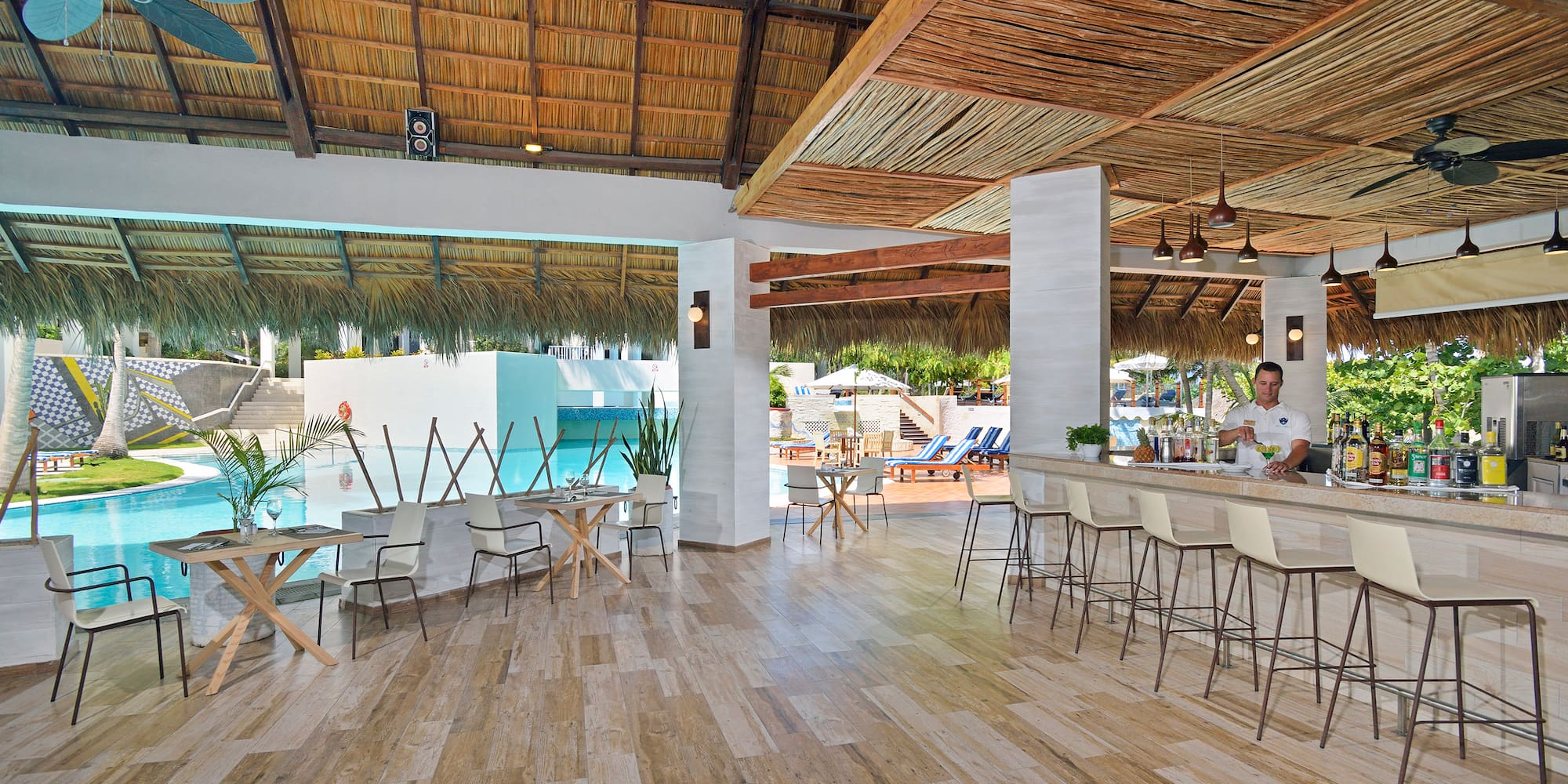 a room with a bar and chairs