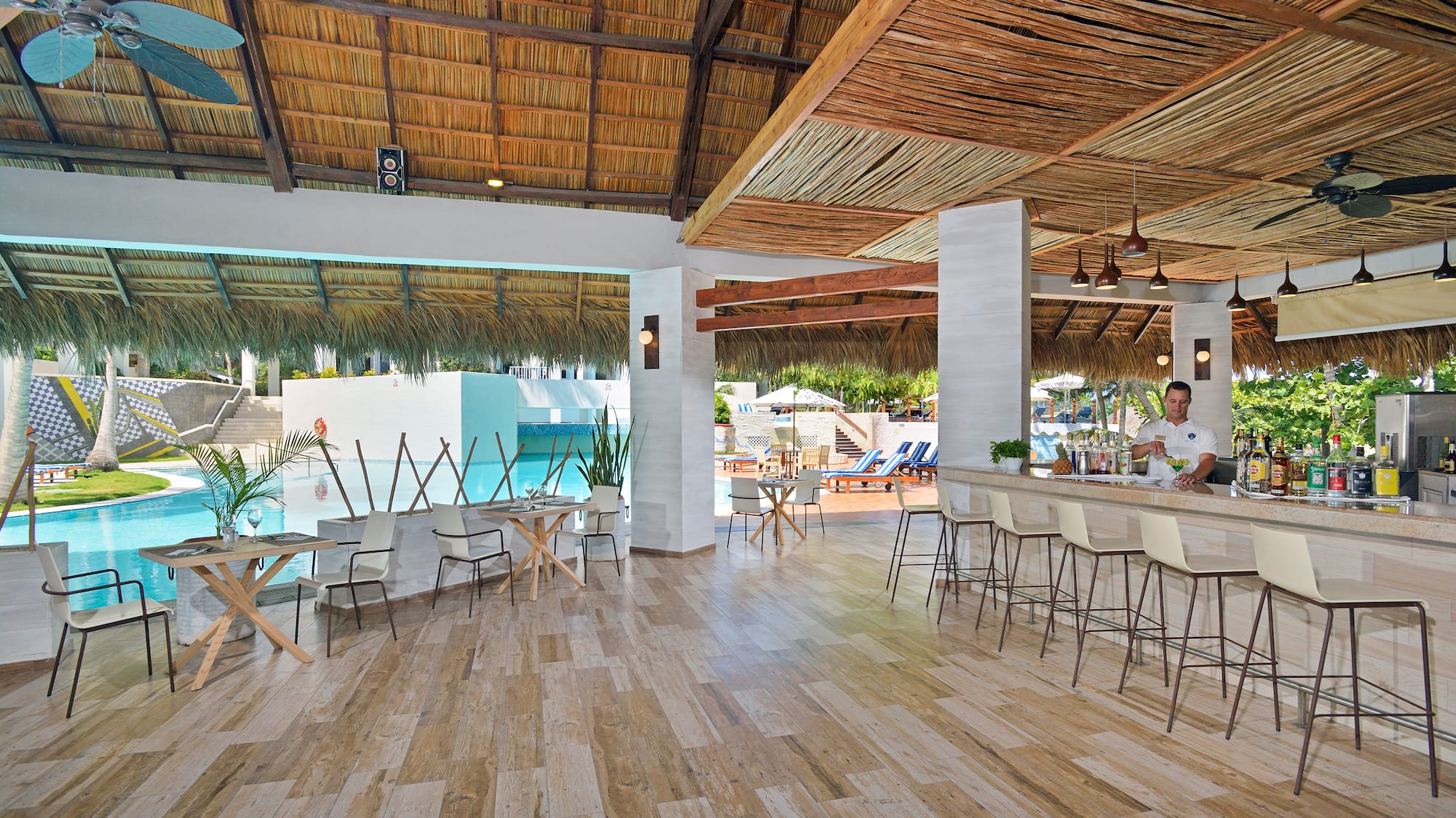 a room with a bar and chairs