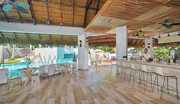 a room with a bar and chairs