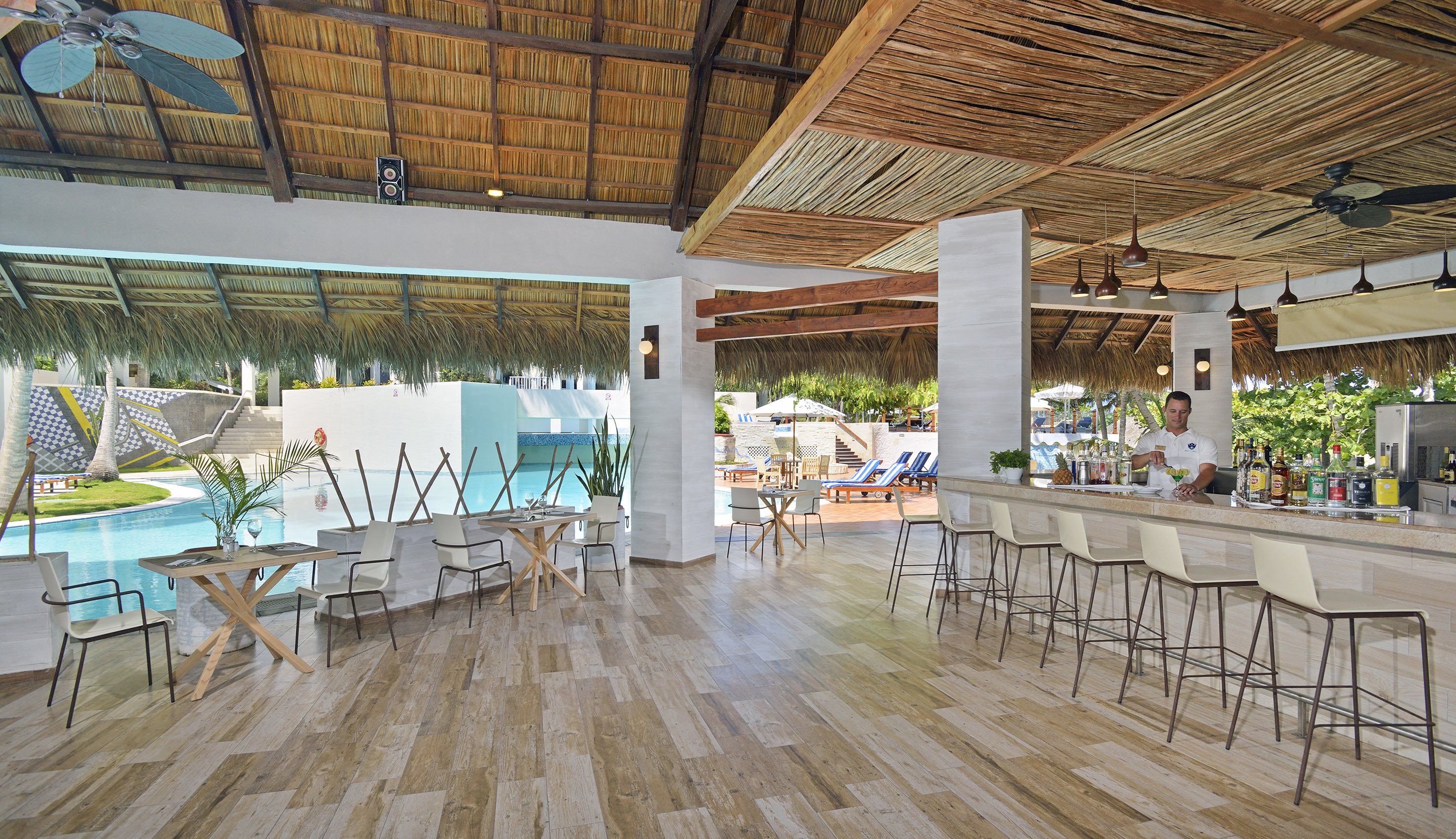 a room with a bar and chairs