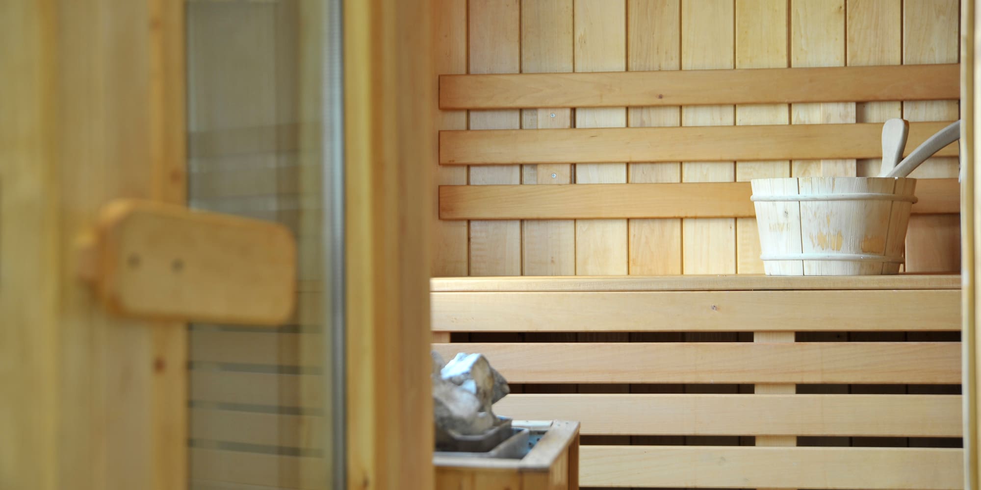 a wooden sauna with a bucket of water