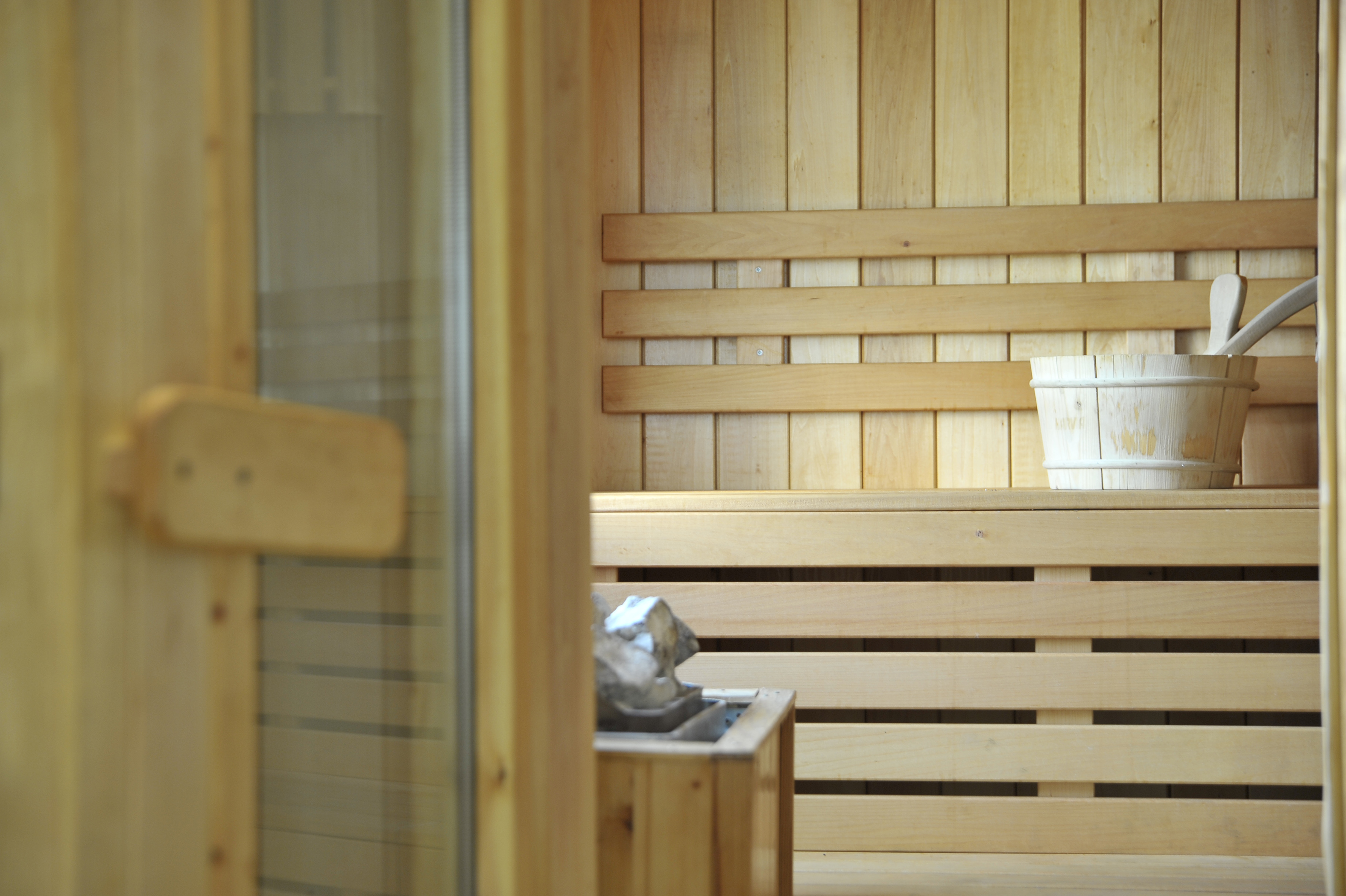 a wooden sauna with a bucket of water