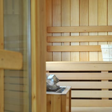 a wooden sauna with a bucket of water