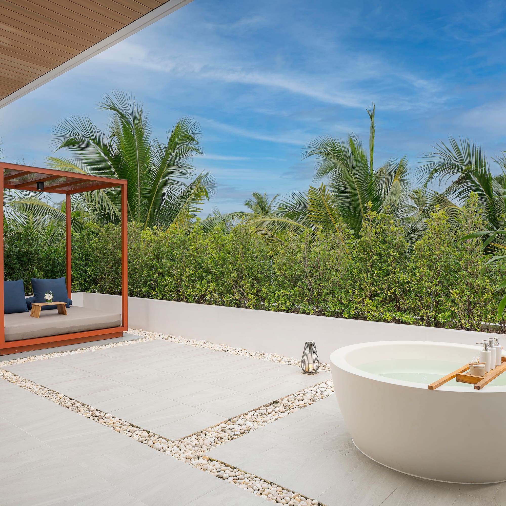 a tub outside with a canopy and a bench