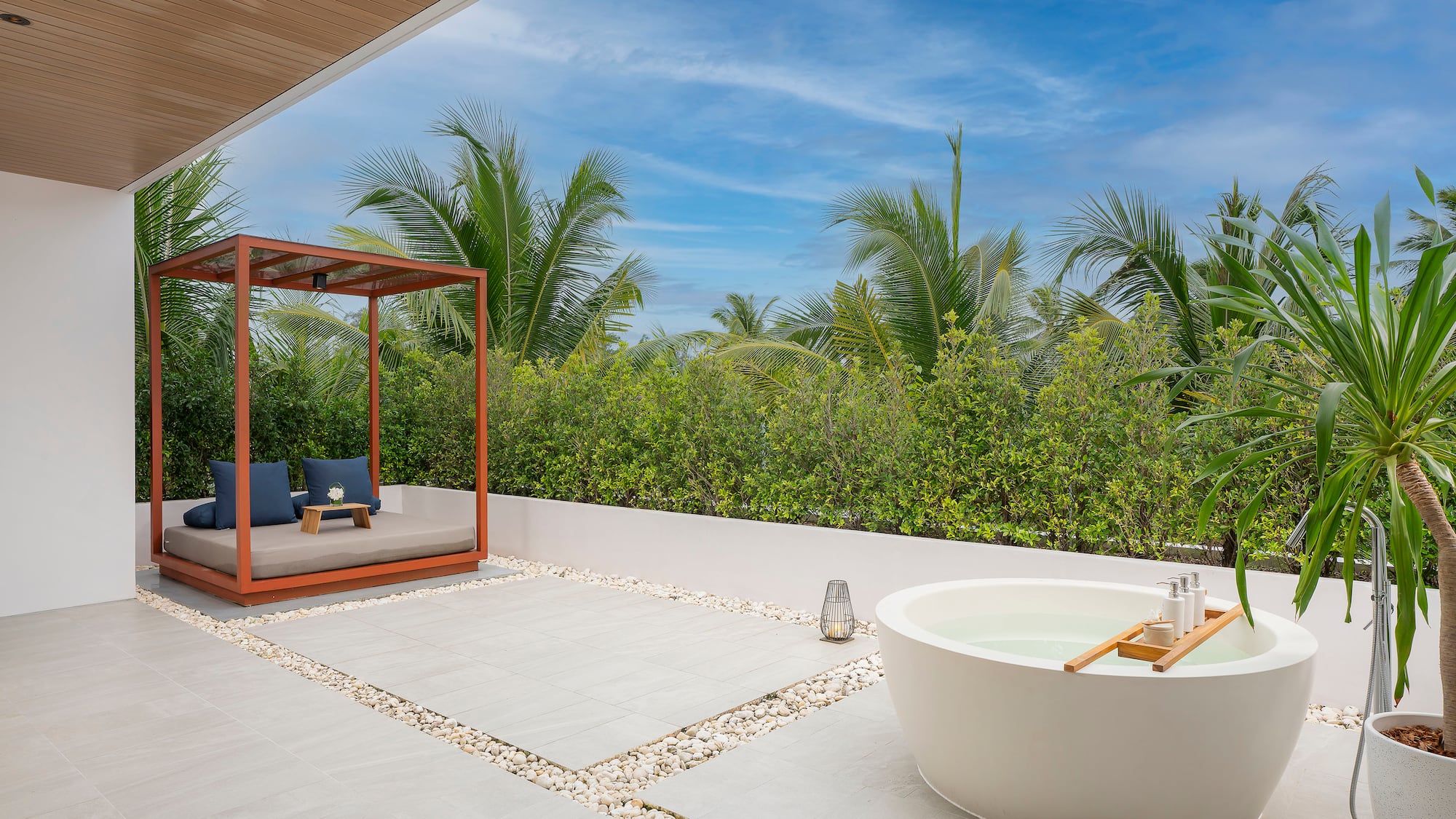 a tub outside with a canopy and a bench