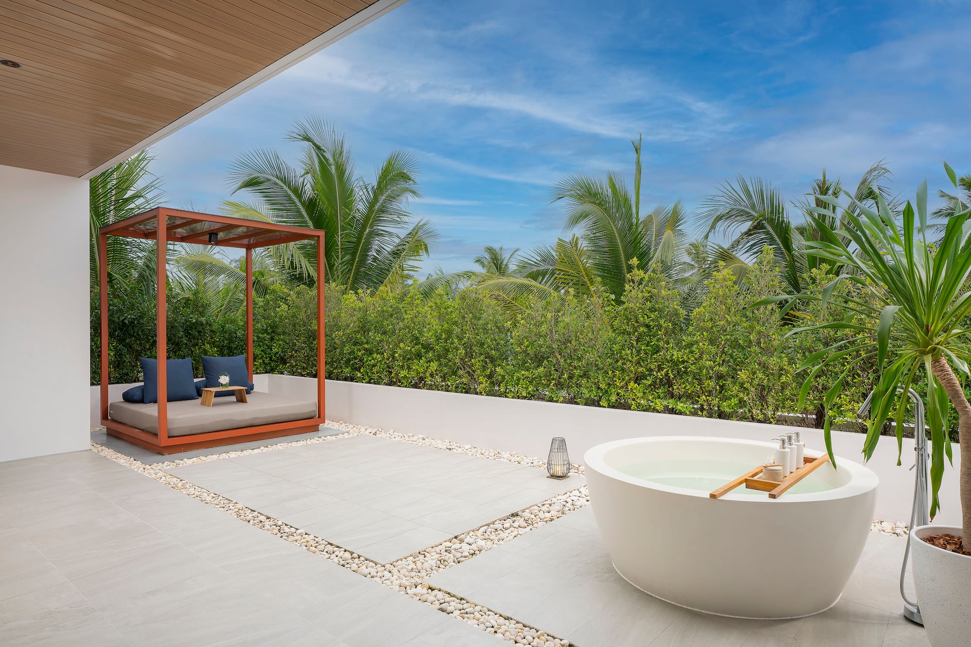 a tub outside with a canopy and a bench