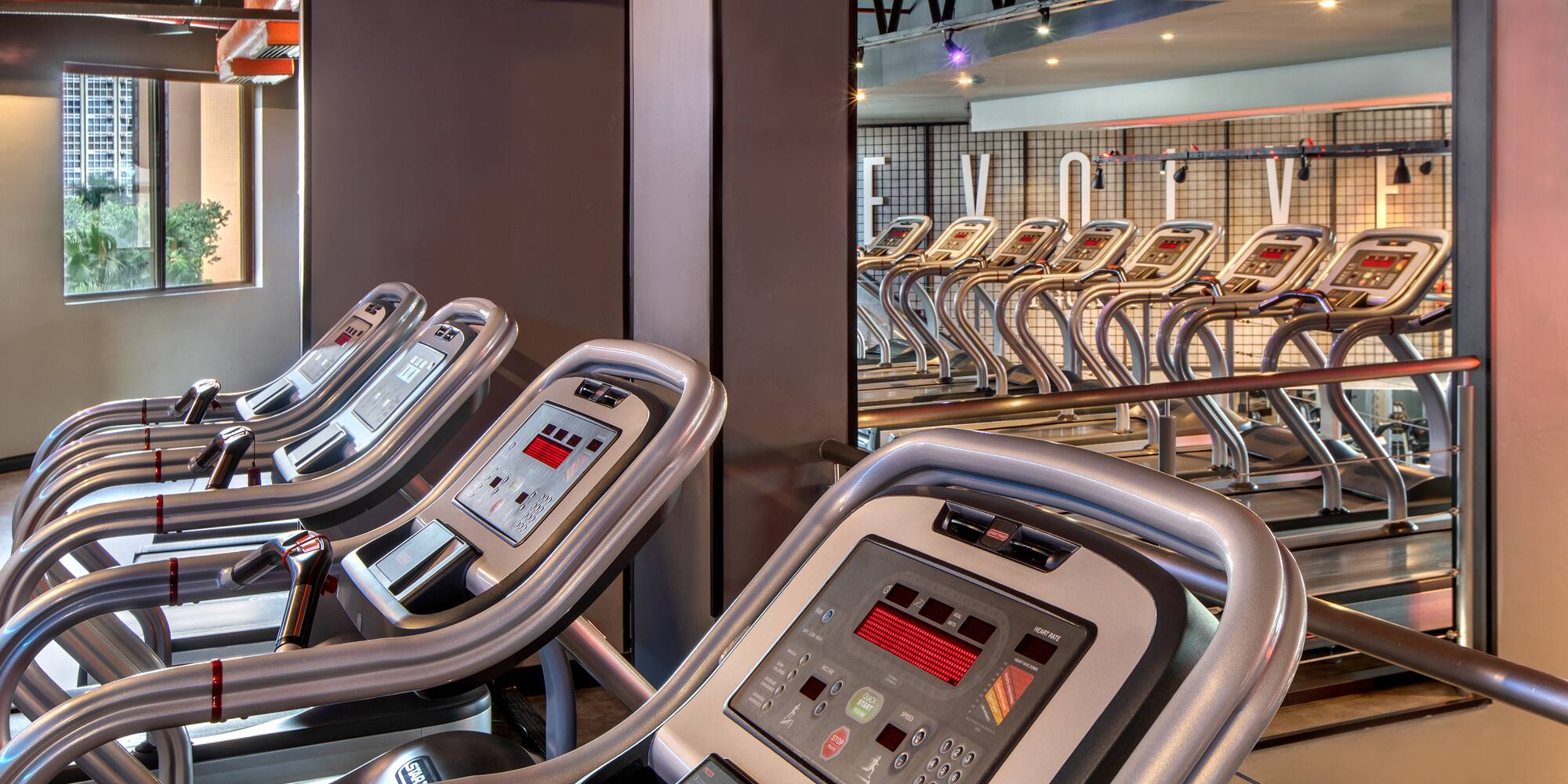 a group of treadmills in a gym