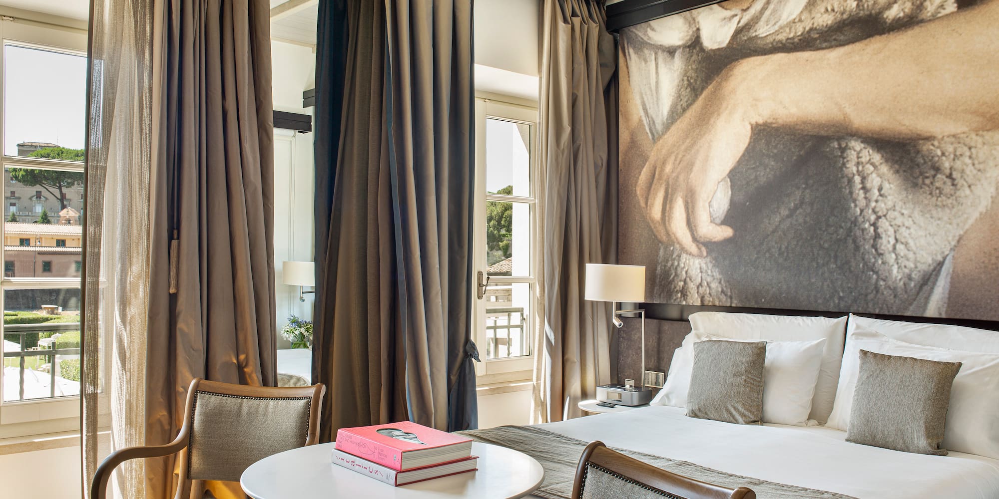 a room with a bed and a table and chairs