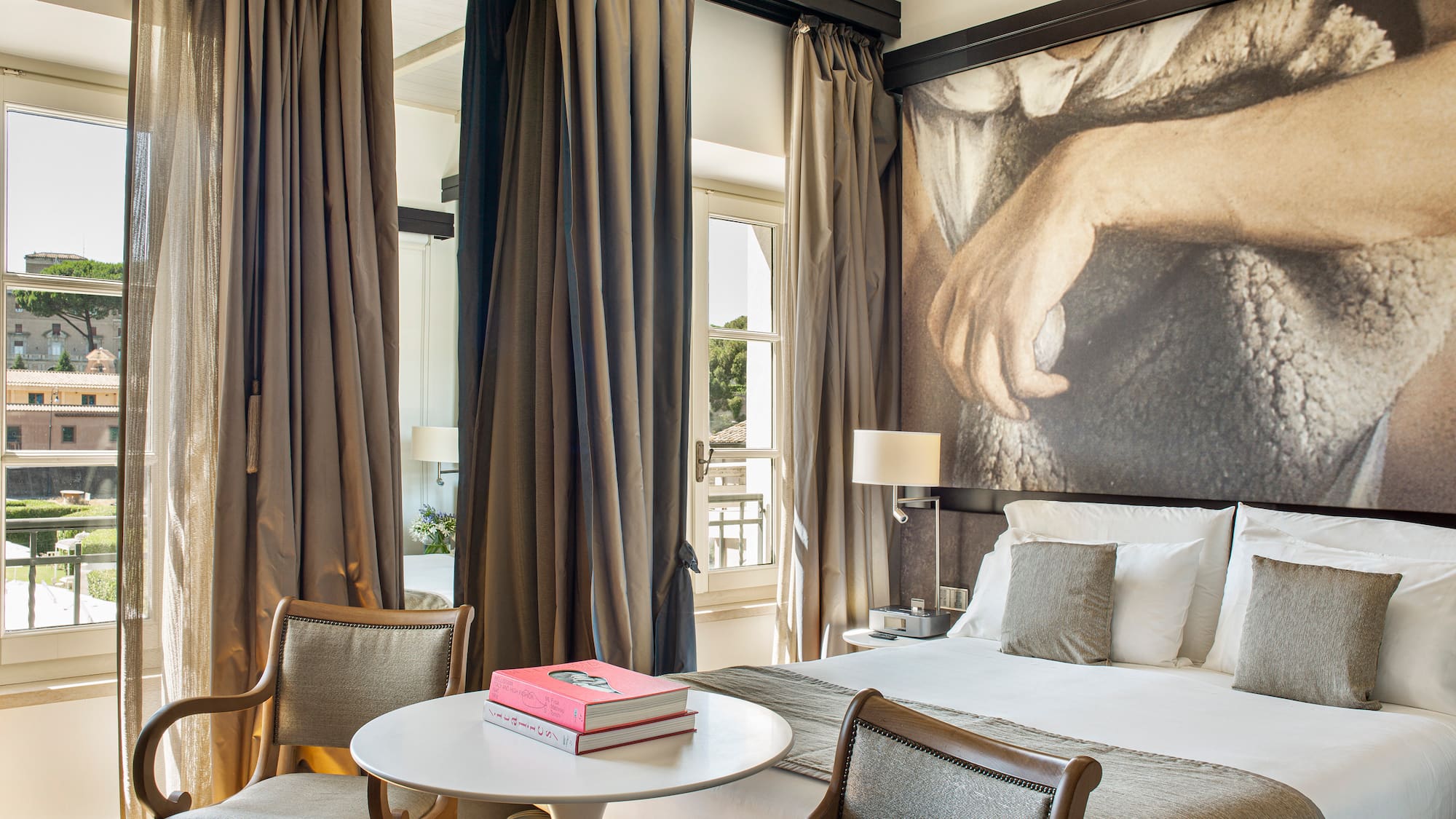 a room with a bed and a table and chairs