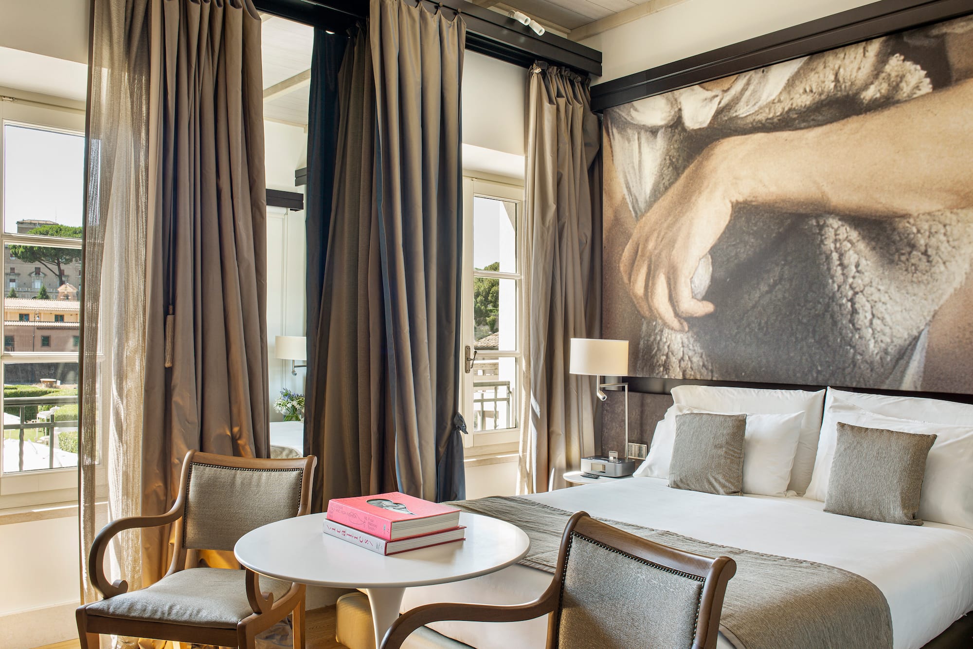 a room with a bed and a table and chairs