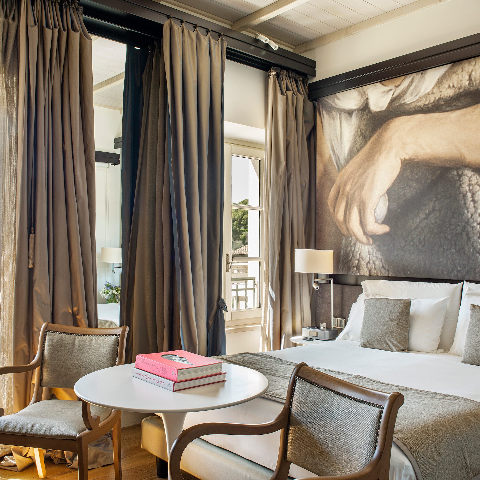 a room with a bed and a table and chairs