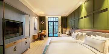 a room with two beds and a television