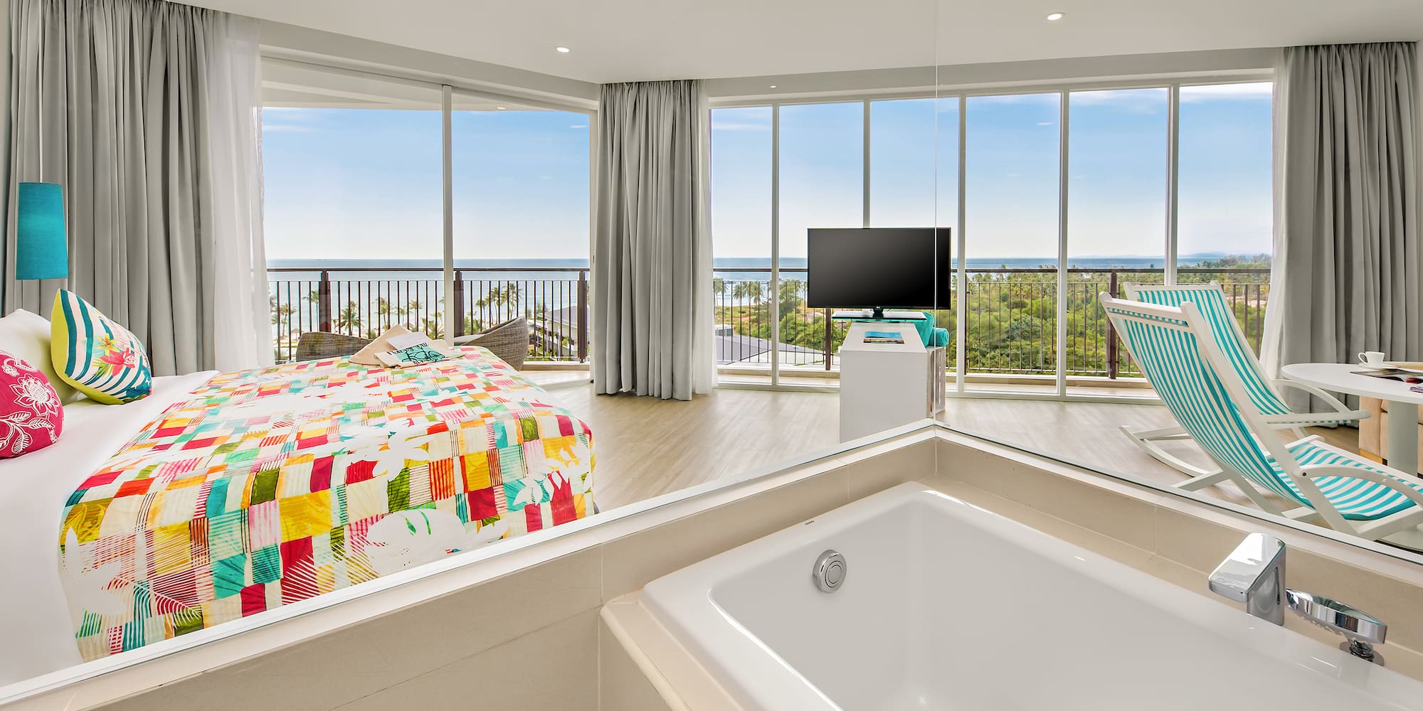 a large room with a bathtub and a television