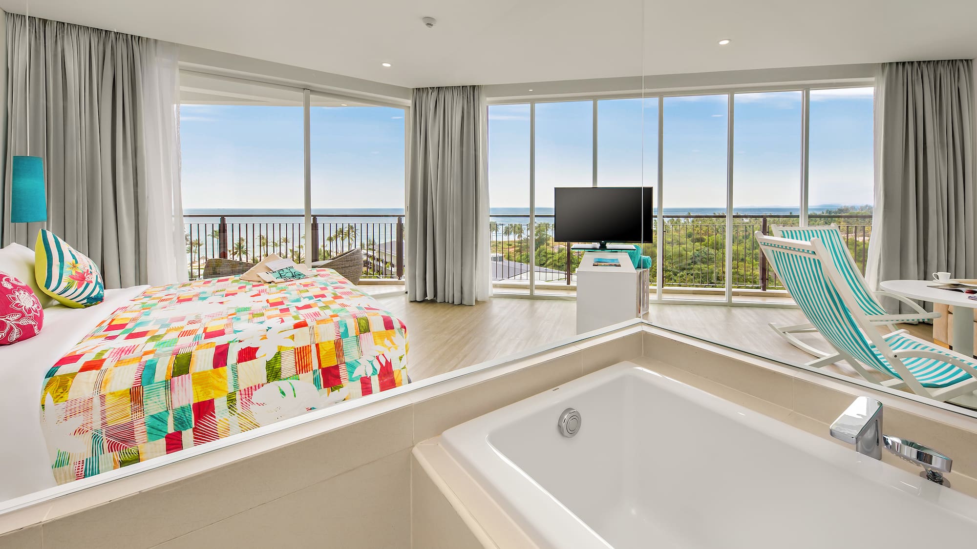 a large room with a bathtub and a television