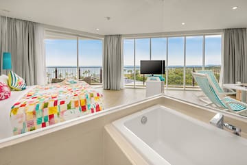 a large room with a bathtub and a television