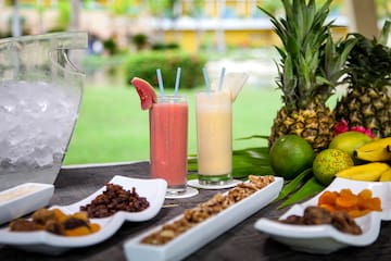 a table with fruit and drinks