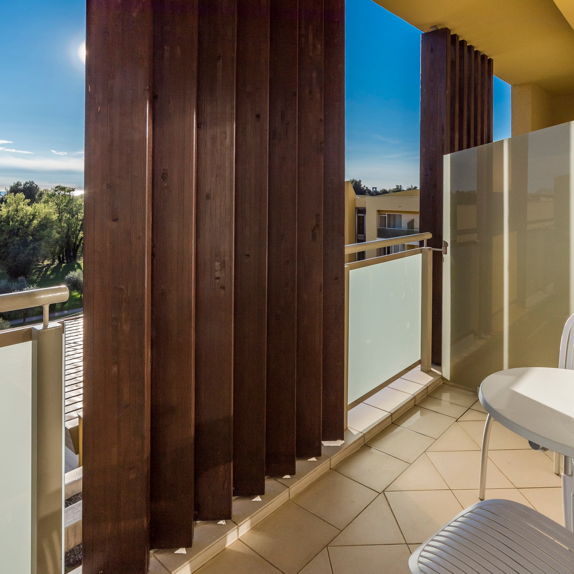 a balcony with a table and chairs