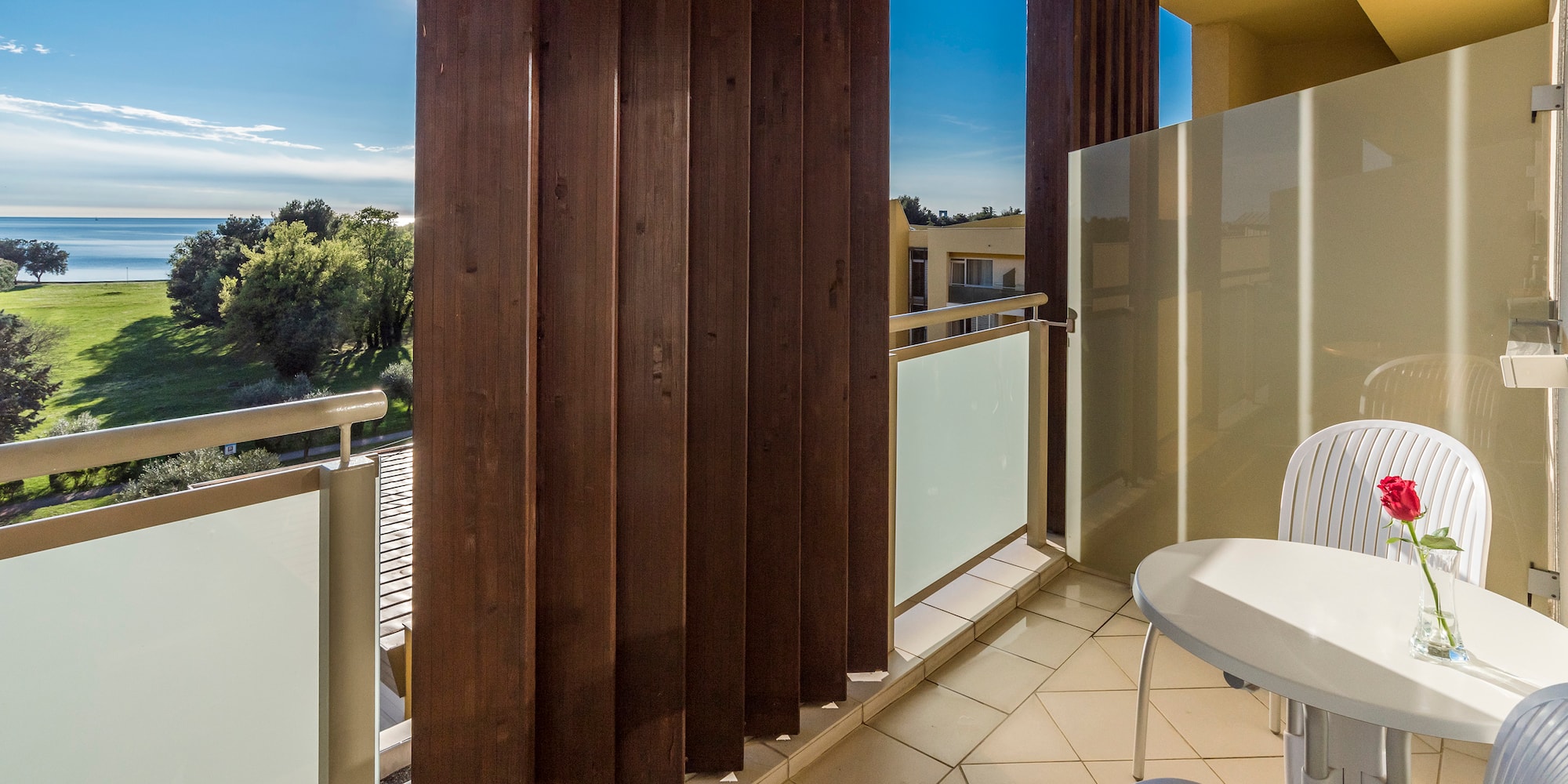 a balcony with a table and chairs