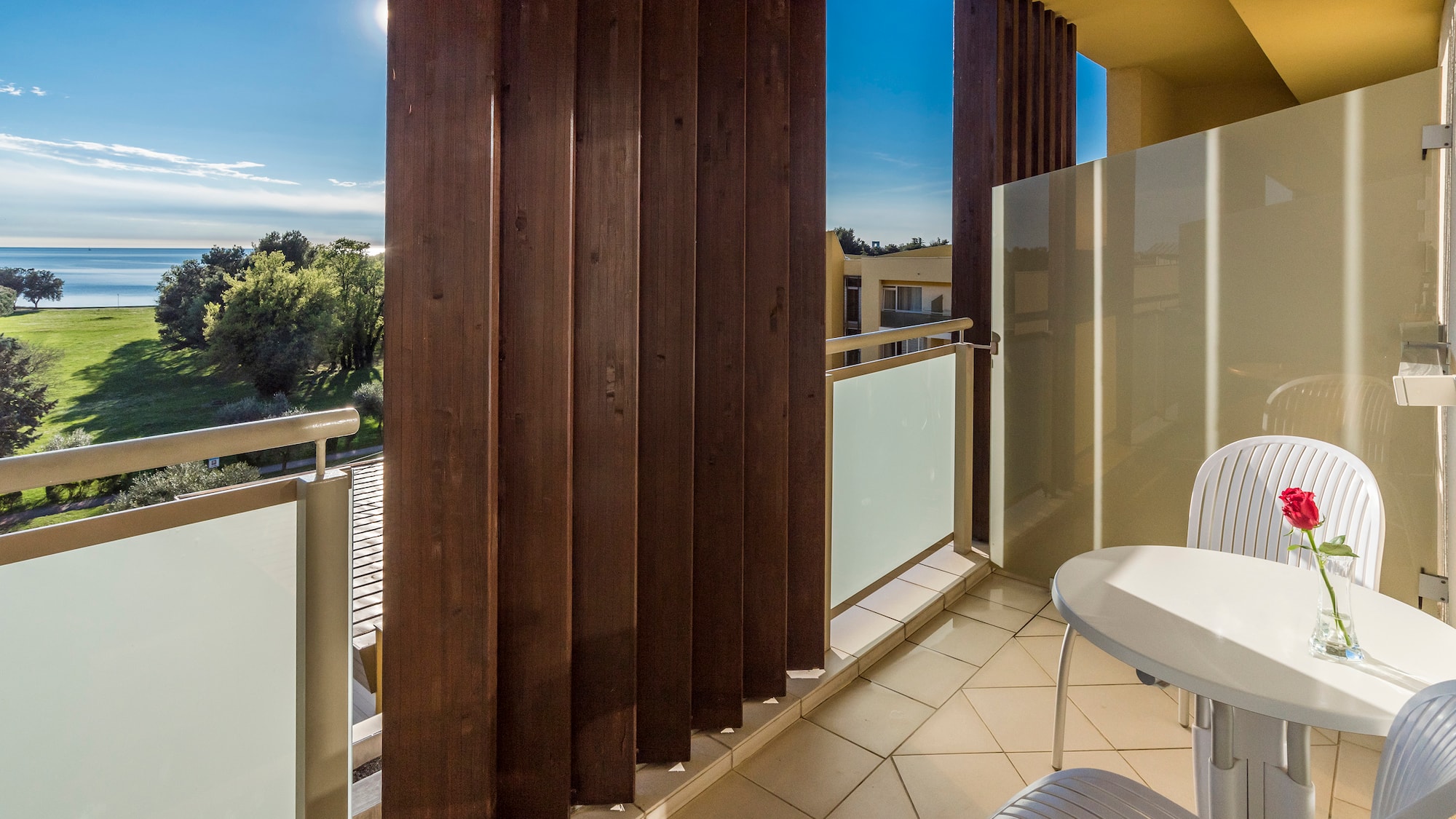 a balcony with a table and chairs